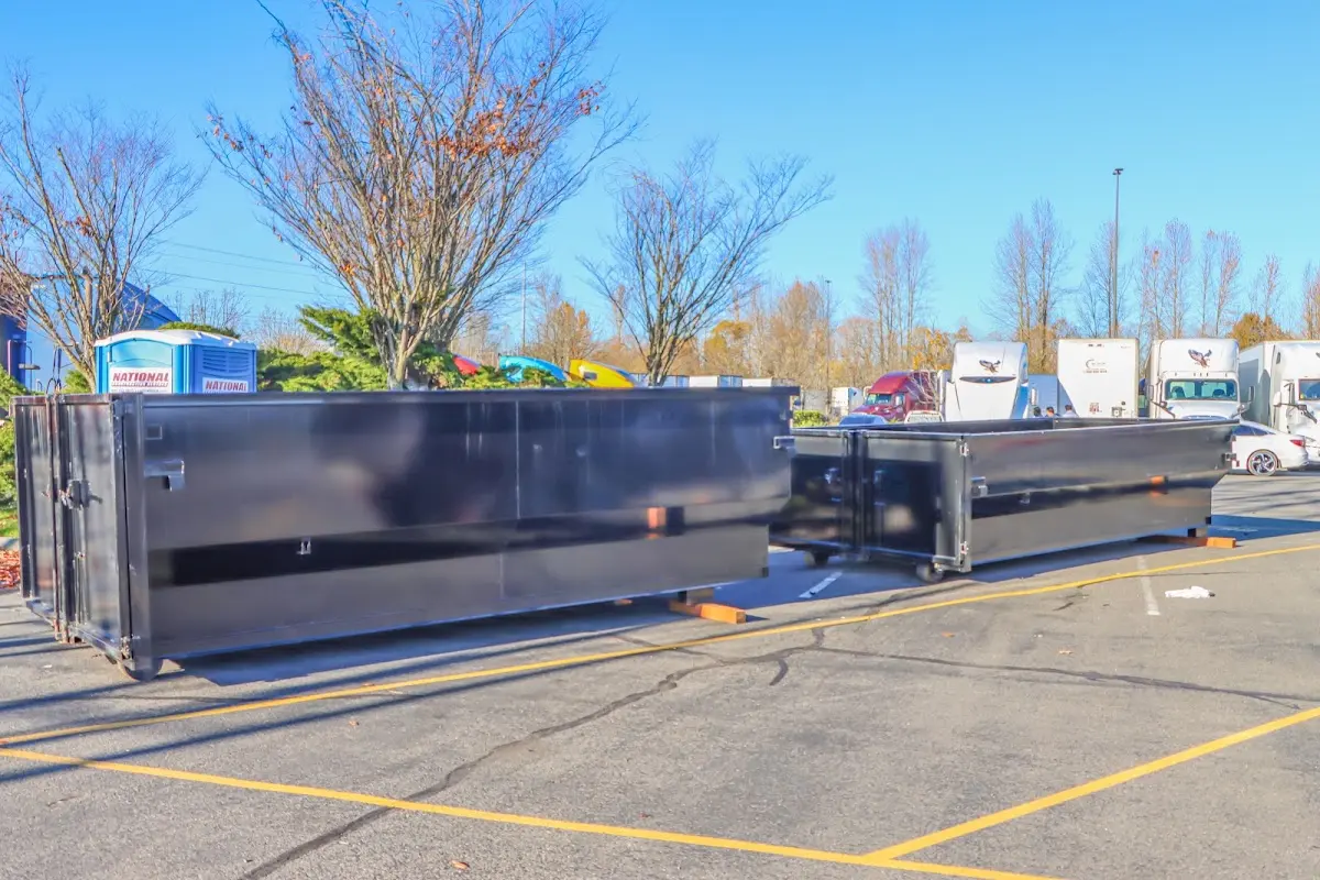 Professional dumpster rental service with roll-off container on residential driveway in Castle Shannon